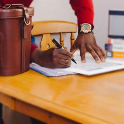 data sharing agreements nfps - man signing agreement on table, unsplash