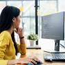 woman in front of laptop with code on the screen